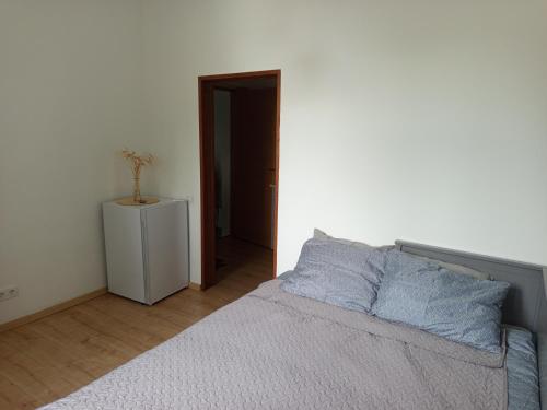 a bedroom with a bed with blue pillows on it at Canalside Studio Loft in Liepāja