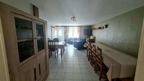 a kitchen and living room with a table and chairs at Gîte LE LOUP in Les Hautes-Rivières