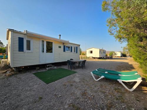 a tiny house with a picnic table at Camping Albox in Albox