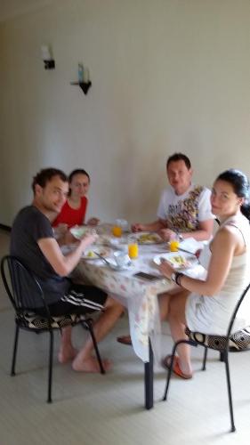 a group of people sitting around a table eating at Villa Paragon in Negombo