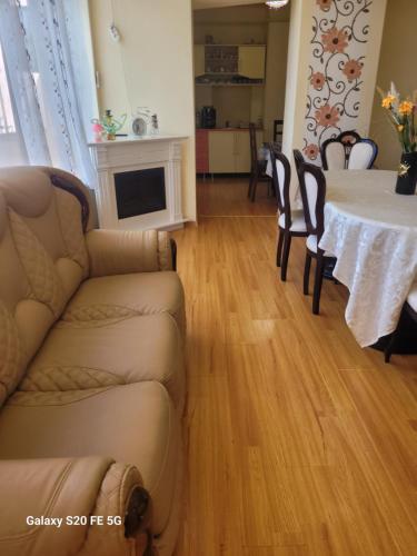 a living room with a couch and a table at Casa Ovi și Simo in Haţeg