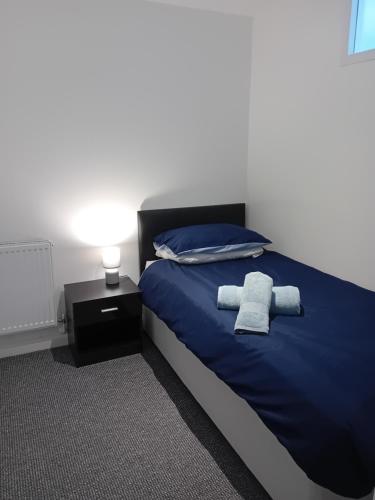 a bedroom with a bed with two towels on it at windies apartment 2 in Bridlington