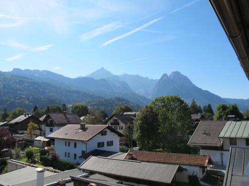 a view of a town with mountains in the background at Hotel garni Almenrausch und Edelweiss in Garmisch-Partenkirchen