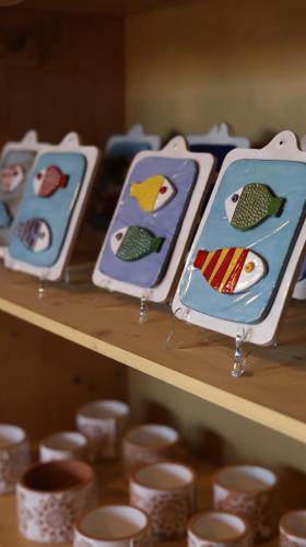 a row of plates with birds on them on a shelf at Podere Campiano in Volterra