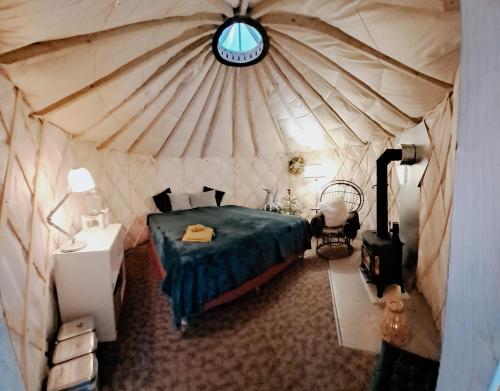 a bedroom with a bed in a yurt at Yurt Birzs with Sauna at Kleja Camping in Eikaži