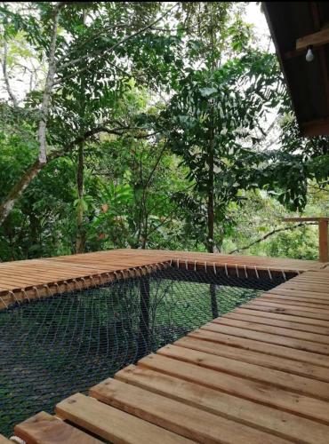 a wooden walkway with a fence and some trees at Ban Mai Chai Dan Home Stay in Satun