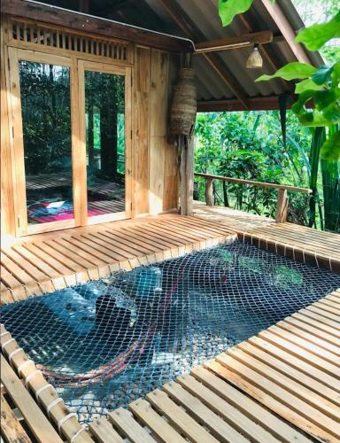 a screened in porch with a chicken coop at Ban Mai Chai Dan Home Stay in Satun