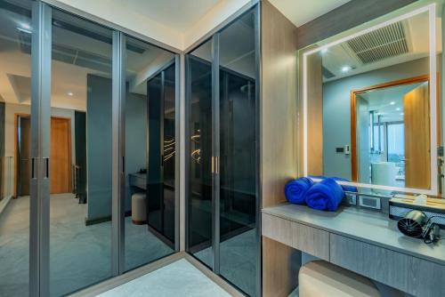 a bathroom with glass walls at Luxury 6BR Seaview Statement Villa - Villa Legend in Ban Saiyuan (1)