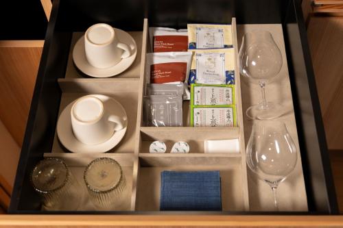 a drawer filled with dishes and wine glasses at 豆家mameya in Tamba-sasayama