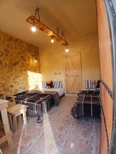 a room with two beds and a barn door at Friends of Dana Hotel in Dana