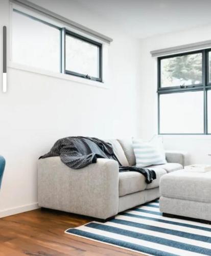 a living room with a couch and a rug at Boutique Flinders apartment in Flinders