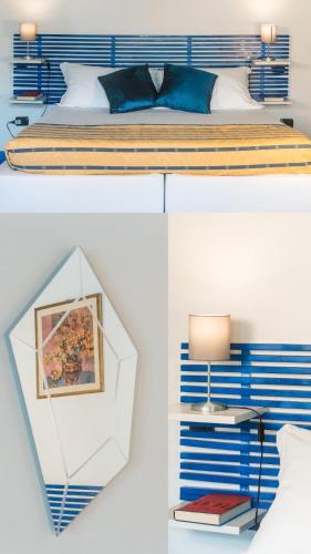 a bedroom with a bed with blue and white stripes at Collina Blu in Orvieto