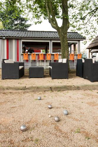 a group of chairs and balls on the ground at Ambiance Hotel in Limas