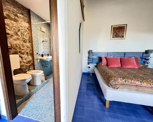 a bedroom with a bed and a bathroom with a toilet at Collina Blu in Orvieto