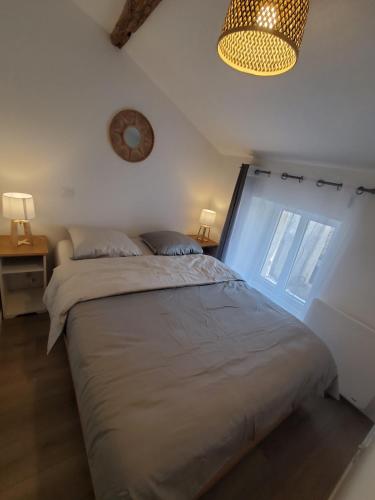 a bedroom with a large bed and a window at Le Cosy, Calme, parking, centre Gémozac in Gémozac
