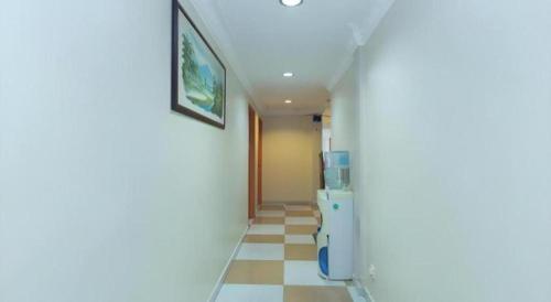 a hallway with a refrigerator in a room at KK Inn Hotel Ampang in Kuala Lumpur