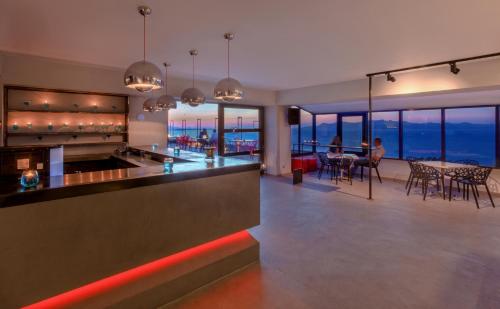 a kitchen and dining room with a view of the ocean at Kipriotis Panorama Hotel & Suites in Kos Town