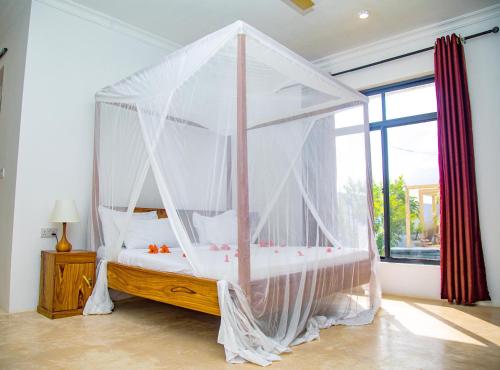 Letto o letti in una camera di Kijiji Villas Nungwi