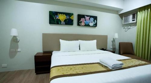 a bedroom with a large white bed in a room at Hotel Fleur de Liz in Panglao