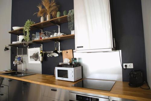 a kitchen with a counter top with a microwave at Modern & Sunny 1BR Apartment with swimming pool in Luxembourg