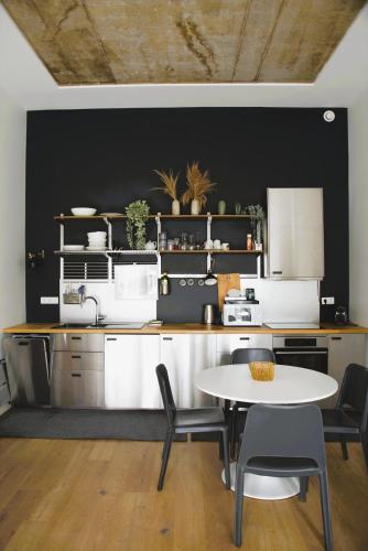 a kitchen with a table and chairs in a room at Modern & Sunny 1BR Apartment with swimming pool in Luxembourg