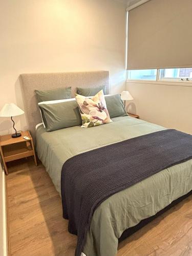 a bedroom with a large bed with a window at Stunning Modern Self-contained Apartment in Beaumont