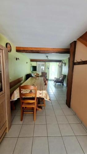 a kitchen and dining room with a table and chairs at Gîte LA COUMERETTE in Les Hautes-Rivières