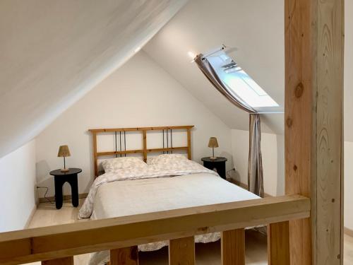 a bedroom with a bed in a attic at Maison Horizon in Ocquier