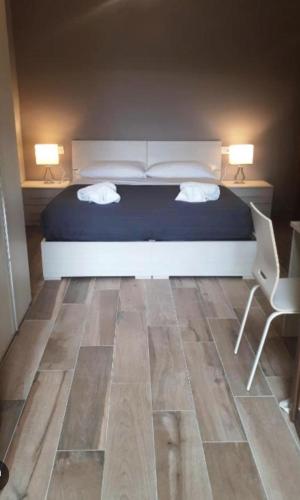 a bedroom with a bed and a desk and a chair at Central in Casarile