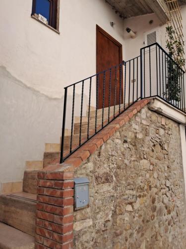 a brick staircase with a gate and a door at Lo SCRIGNO in San Giorgio Montagna