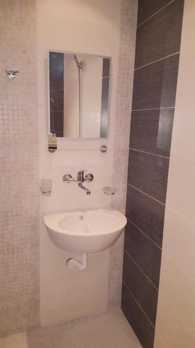 a bathroom with a sink and a mirror at Guest House Bogat-Beden in Ravda