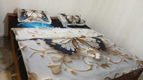 a bed with two pillows on top of it at White Sand Haven Guest House in Ebhausen