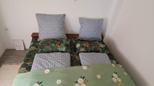 a bed with two pillows on it in a room at White Sand Haven Guest House in Ebhausen