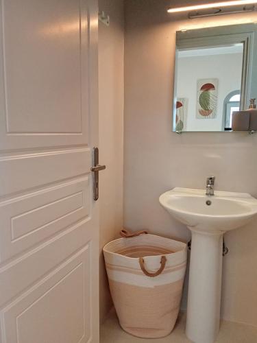 a bathroom with a sink and a toilet and a door at Aktaea, Seaside Residence in Santa Maria