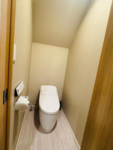 a bathroom with a toilet in a small room at 新小岩AhaiHotel in Wada