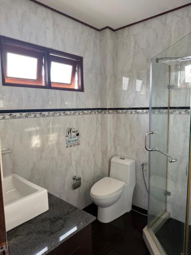 a bathroom with a toilet and a glass shower at Sweet home in Bangrak Beach