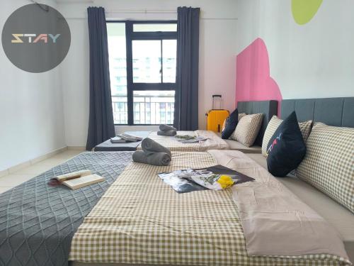 a bedroom with two beds and a large window at The Garden 1Bed Comfort Joyful Netflix BySTAY in Skudai
