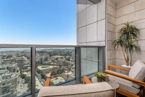 an apartment balcony with a view of the city at Unique Masterpiece in the Heart of Jerusalem in Jerusalem
