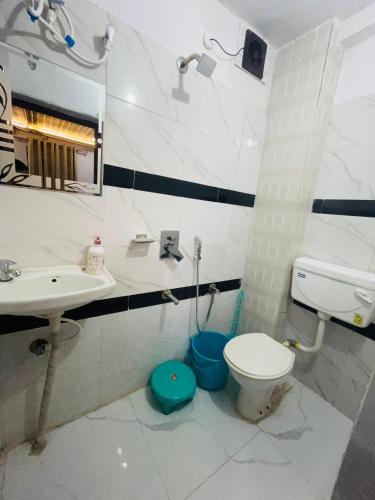 a bathroom with a toilet and a sink at The Ghat House in Varanasi