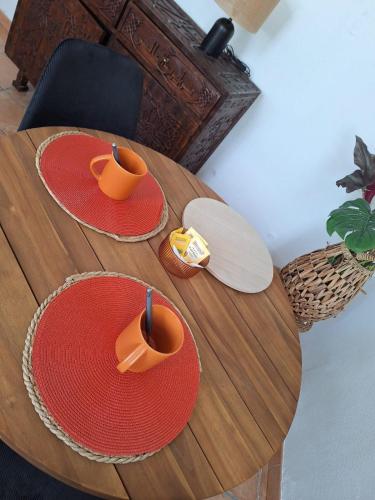 a wooden table with two hats on top of it at Le Champigny in Champigny-sur-Yonne