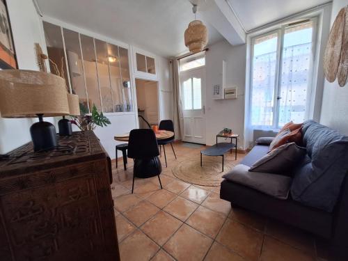 a living room with a couch and a table at Le Champigny in Champigny-sur-Yonne