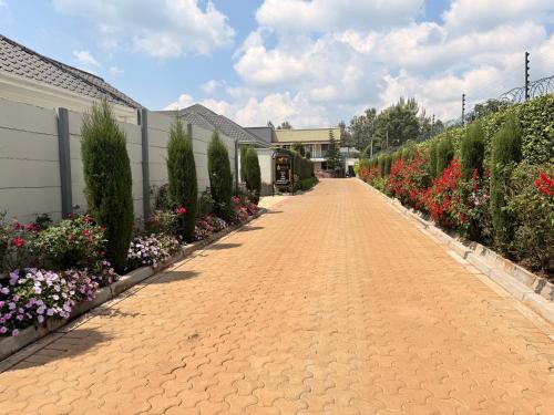a brick road with flowers on the side of a building at Blueberry Villas in Eldoret