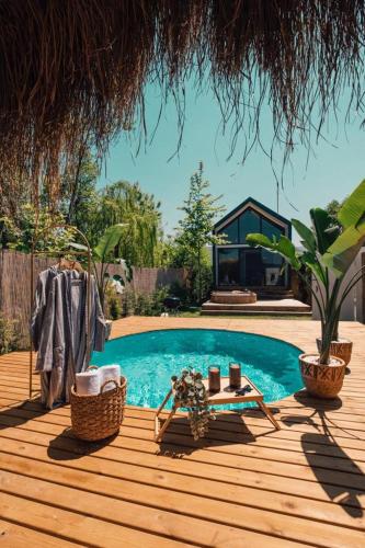a swimming pool on a wooden deck next to a house at Boheme Bungalow Sapanca in Sapanca