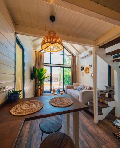 a living room with a table and some chairs at Boheme Bungalow Sapanca in Sapanca