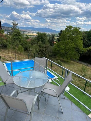 a patio with a table and chairs and a pool at Royal Haven 