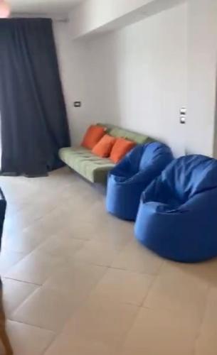 a living room with a couch with pillows on it at Elite residence ain elsokna in Ain Sokhna