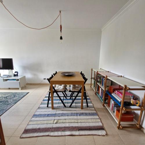 a dining room with a table and a book shelf at Apartamento do Paço do Lumiar in Lisbon
