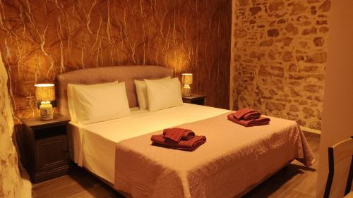 a bedroom with a bed with two towels on it at Casa Stratigos in Corfu