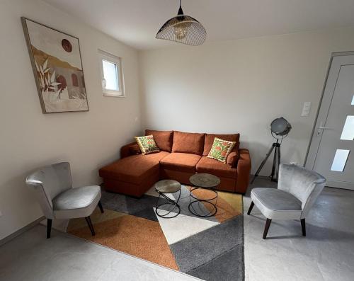 a living room with a couch and two chairs at La Cigogne du Ried in Wittisheim