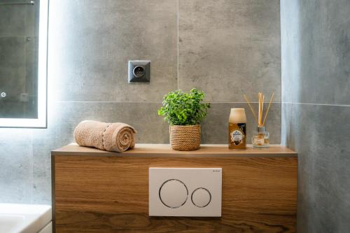 a bathroom with a counter with a sink and a bath tub at Chaty ForRest in Valča